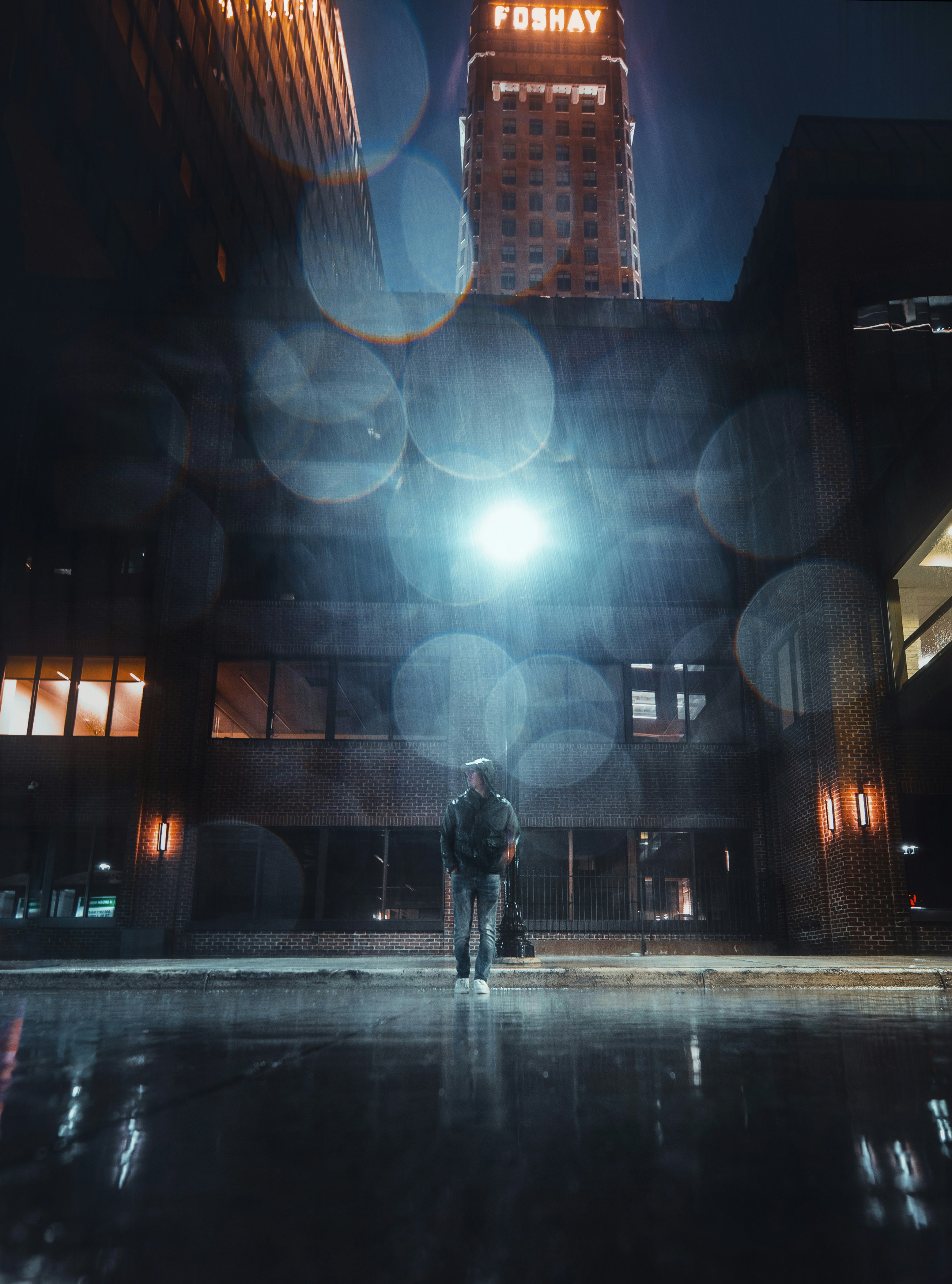 man walking on street during night time